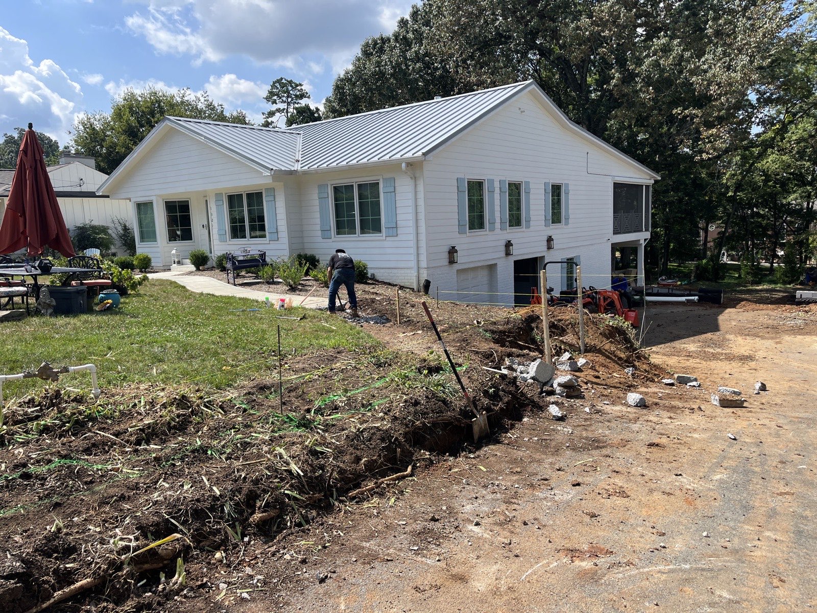 North Shore front yard before renovation — trenched dirt and construction