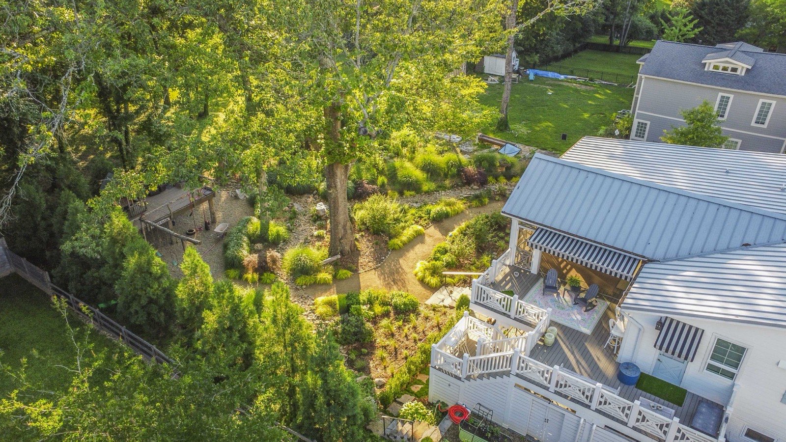 Bird's-eye view of the terraced garden, heritage oak, and winding paths