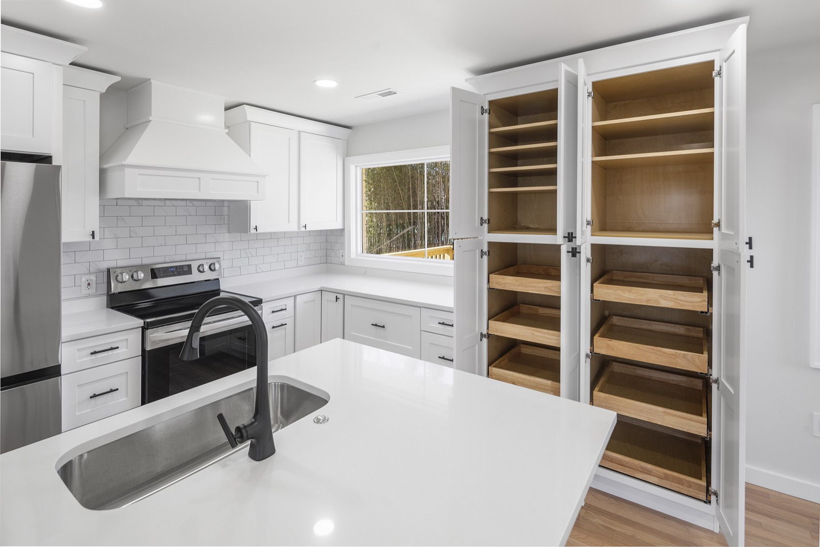 Floor-to-ceiling pantry with custom wood pull-out shelving