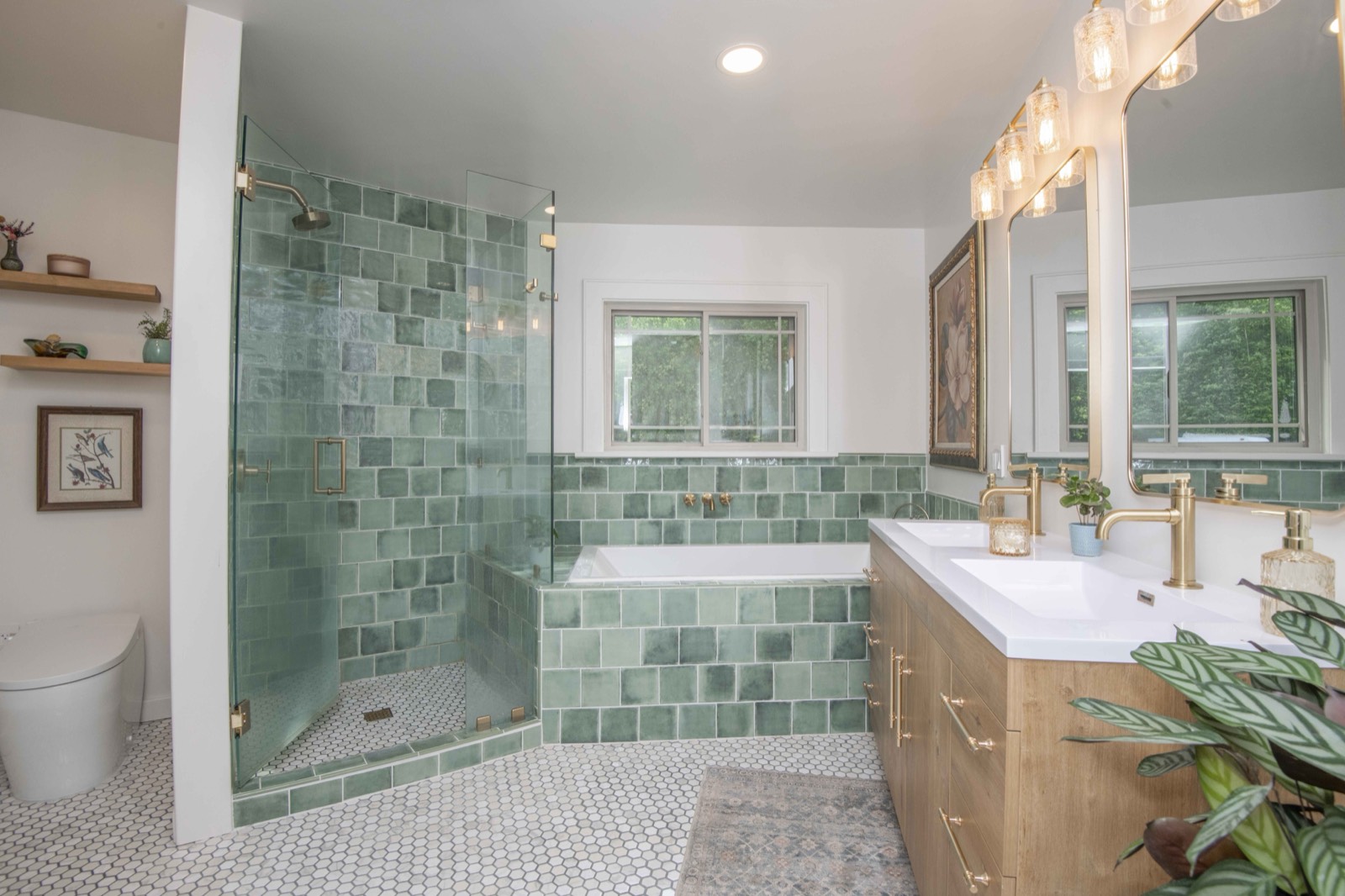 Spa-style bath with green tile, soaking tub, and double wood vanity