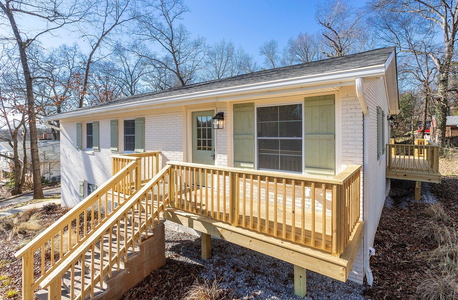 Freshly painted home with a new pressure-treated deck and railings