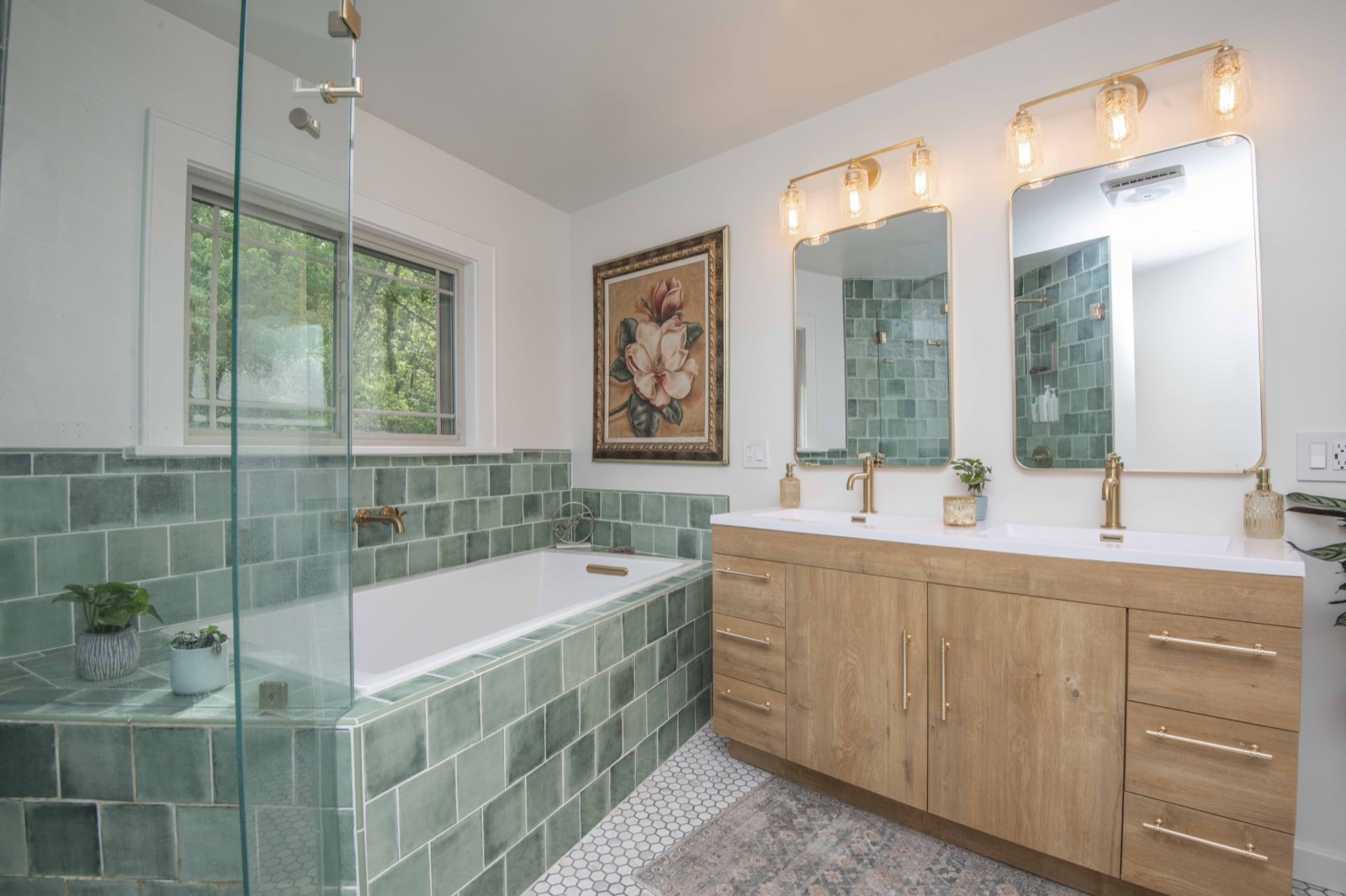 Green-tile bath with a wood double vanity, soaking tub, and glass shower