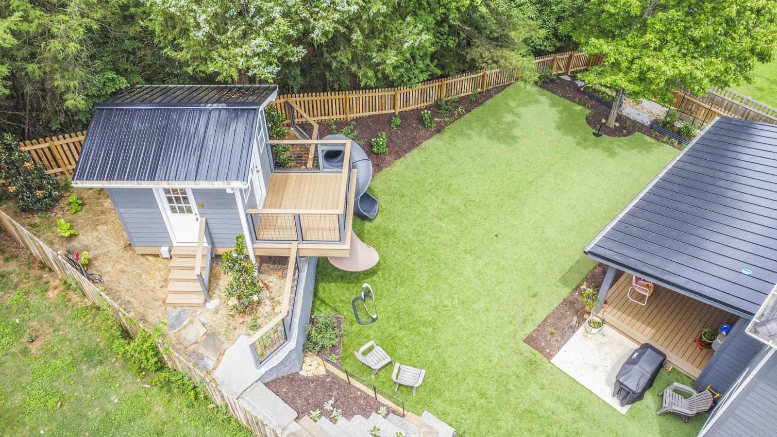 Bird's-eye view of the artificial-turf lawn, playhouse, and covered patio